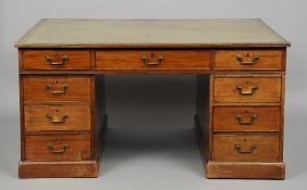 An early 19th century mahogany pedestal partner's desk
The single piece tooled leather top with a