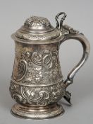 A George II silver lidded tankard, hallmarked London 1749, makers mark indistinct
The hinged cover