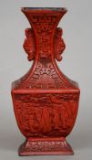 A late 19th/early 20th century Chinese cinnabar lacquered vase
The sweeping neck with twin