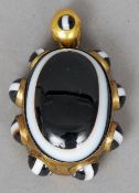 A yellow metal framed cabochon banded agate set pendant
The reverse with picture aperture.  5 cms
