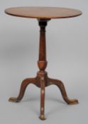 An 18th century and later yewwood and mahogany tripod table
The oval mahogany top above the turned