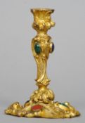 A 19th century ormolu scroll cast and mineral mounted taperstick
10.5 cms high.   CONDITION REPORTS: