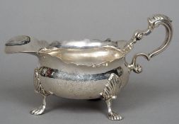 A George II silver sauceboat, hallmarked London 1749, makers mark indistinct
With scalloped rim,