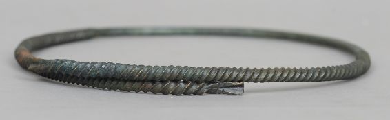 An antique bronze neck torque
With banded spiral decoration, possibly 8th century Viking.  21 cms