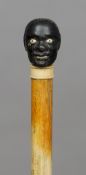 A 19th century whale bone walking stick
The single piece shaft mounted with an ivory inset carved