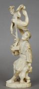 A 19th century Japanese ivory okimono
Formed as a gentleman holding aloft an acrobatic lady, the