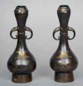 A pair of 17th century Chinese bronze onion neck twin handled vases
Each incised with gilded