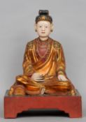 A 19th century Oriental painted and carved giltwood model of Buddha
Typically modelled in the