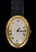 An 18 ct gold cased Cartier lady's wristwatch
Of domed oval form, the winder set with a cabochon