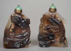 A Chinese carved agate snuff bottle
Worked with a mythical beast, the cover green stone inset.  5.