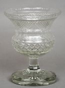 A 19th century cut glass vase
With flared rim, standing on a circular foot.  25.5 cms high.