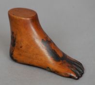 A 19th century boxwood snuff box
Formed as a human foot, the underside with a hinged lidded