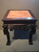 A pair of Chinese marble inset carved hardwood urn stands
The square tops above a carved frieze,