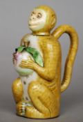 An early 20th century Chinese enamel decorated teapot
Formed as monkey holding a fruit.  14 cms