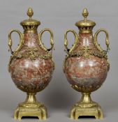 A pair of gilt metal mounted marble baluster urns
Each with acanthus cast cover with pineapple