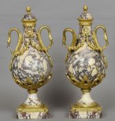 A pair of gilt metal mounted baluster urns
Each with acanthus cast cover with pineapple finial above