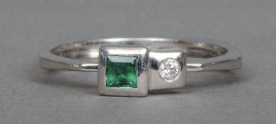 An 18 ct white gold diamond and emerald set designer ring by Yilanda Kurulan Storks   CONDITION