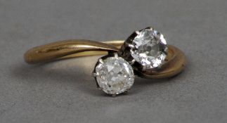 A 9 ct gold diamond two stone crossover ring
   CONDITION REPORTS:  Some inclusions to stones,