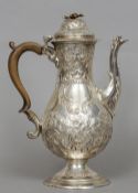 A silver coffee pot, hallmarks indistinct
Of baluster form with an acanthus cast scrolling spout and