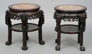 A pair of late 19th/early 20th century Chinese carved hardwood side tables
Each with a marble