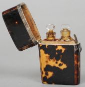 A 19th century white metal mounted tortoiseshell scent bottle case
Containing two small glass