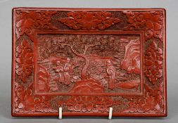 A 19th century Chinese cinnabar lacquered tray
Centrally decorated with figures in a landscape.