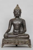 An Eastern bronze figure of Buddha
Seated in the lotus position, on a pierced triangular plinth base