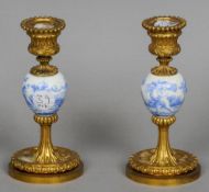 A pair of 19th century Continental porcelain mounted ormolu candlesticks
Each centred with a blue