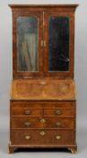 An 18th century walnut bureau cabinet
The moulded rectangular cornice above twin bevelled mirrored