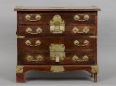 A late 19th/early 20th century Chinese  miniature chest of drawers
The moulded rectangular brass