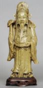 A Chinese carved soapstone figure of an emperor
Modelled holding a ruyi sceptre, standing on a