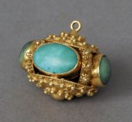 An unmarked gold pendant, possibly Indian, probably high carat gold
Set with green cabochon stones.