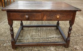 An 18th century oak refectory type table
The cleated plank top above two frieze drawers, standing on