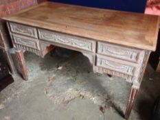 A late 19th century limed oak desk
The moulded rectangular top above five carved drawers with five