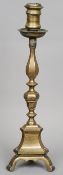 An 18th century bronze candlestick
Of tall knopped form above the triangular base, standing on three