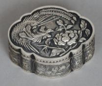 A small 19th century Chinese silver snuff box
Of lobed form, the removable lid decorated with a bird