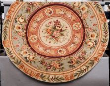 An Aubusson wool rug
Typically worked with floral sprays, circular.  182 cms diameter.   CONDITION