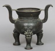 A Ming period Chinese bronze twin handled censor
Standing on mythical beast mask headed cabriole