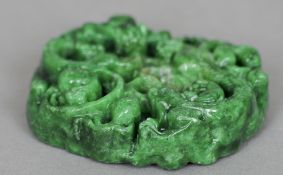 A Chinese dark green jade carved pendant
The top decorated with dragons.  5 cms high.   CONDITION