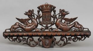 A 19th century carved oak pipe rack
Ornately carved with a heraldic crest.  70 cms wide.   CONDITION