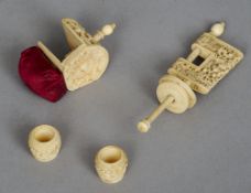 Four Chinese carved ivory sewing accoutrements
Including: two clamps and two small vessels.  The
