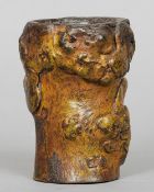 An antique Chinese rootwood brush pot
The one piece bird vessel with traces of gilt decoration.