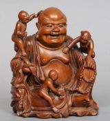 A 19th century carved wooden figural group
Formed as Buddha holding a ruyi sceptre and beads with