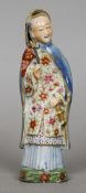An 18th century Chinese porcelain figure
Formed as a woman in gilt heightened florally decorated