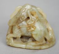 A small Chinese carved jade group
Modelled as various mythical beasts, standing on a pierced