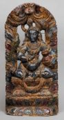 A Tibetan carved wooden panel
Centrally carved with a deity, a bird on her shoulder, with painted