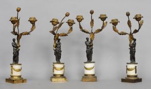 Four 19th century ormolu mounted bronze twin branch candlesticks
Each of scrolling floral form