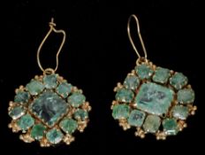 A pair of unmarked gold mounted emerald drop earrings
Of lozenge shape.  Each 2.75 cms wide.