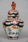 A 17th century Japanese Imari vase and cover
Of bulbous form, the main body decorated with
