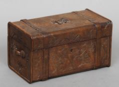 A 19th century Continental carved wooden box
Formed as a travelling trunk with floral decoration.